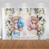 A gender reveal backdrop featuring teddy bears and balloons with floral greenery for a baby shower.