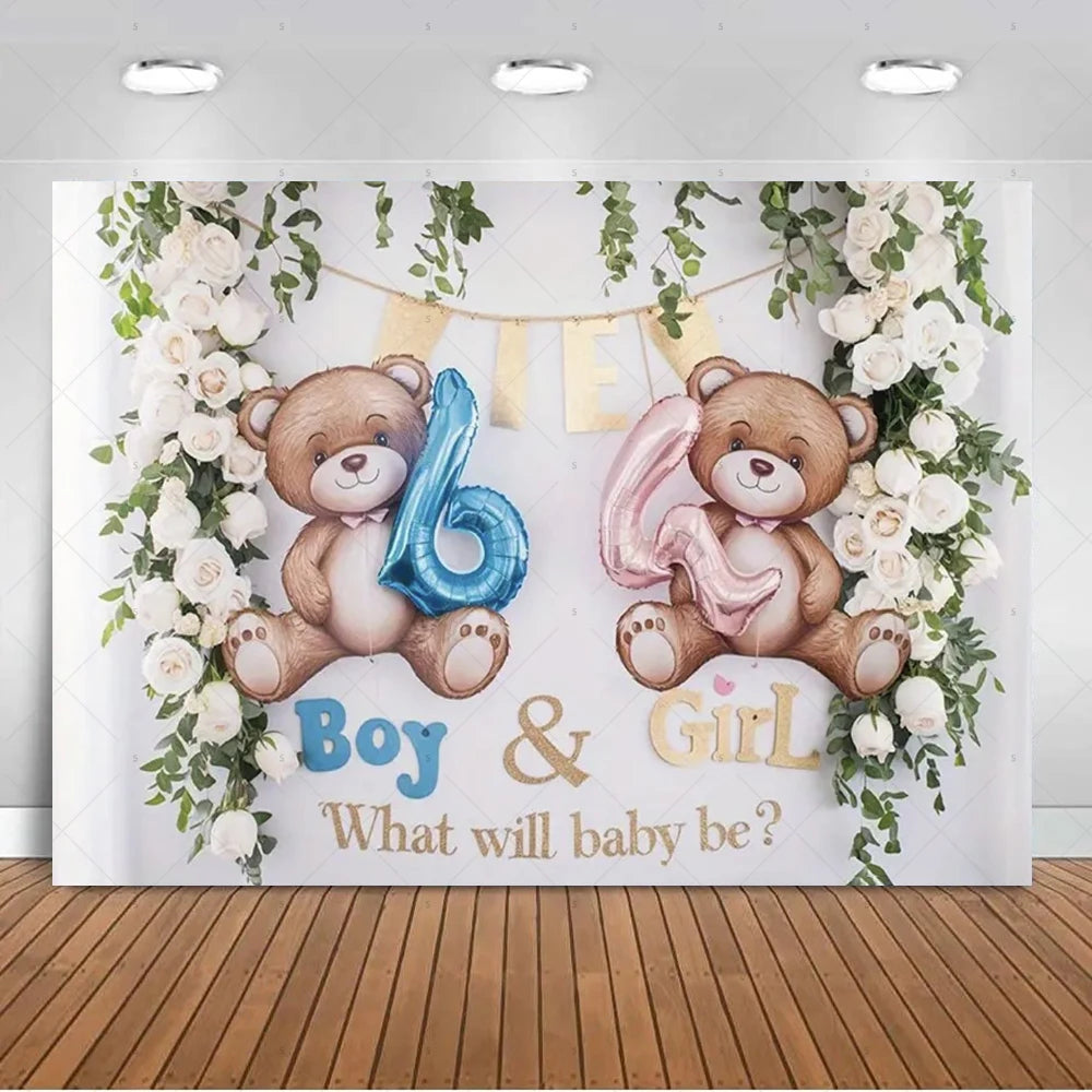 A gender reveal backdrop featuring teddy bears and balloons with floral greenery for a baby shower.