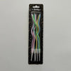 A pack of long, thin spiral birthday candles in various pastel colors, including pink, green, and blue.