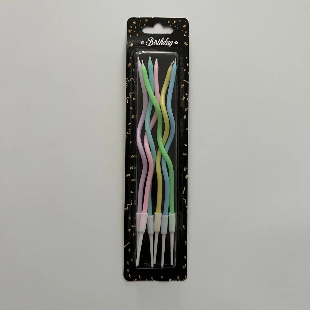 A pack of long, thin spiral birthday candles in various pastel colors, including pink, green, and blue.