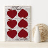 A gallery art print featuring red apple shapes on a vintage newspaper background.