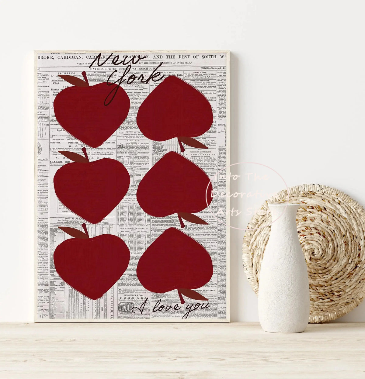 A gallery art print featuring red apple shapes on a vintage newspaper background.