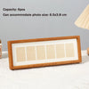 A wooden photo frame display stand with six rectangular slots for photos.