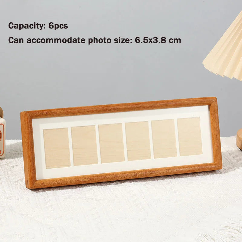A wooden photo frame display stand with six rectangular slots for photos.