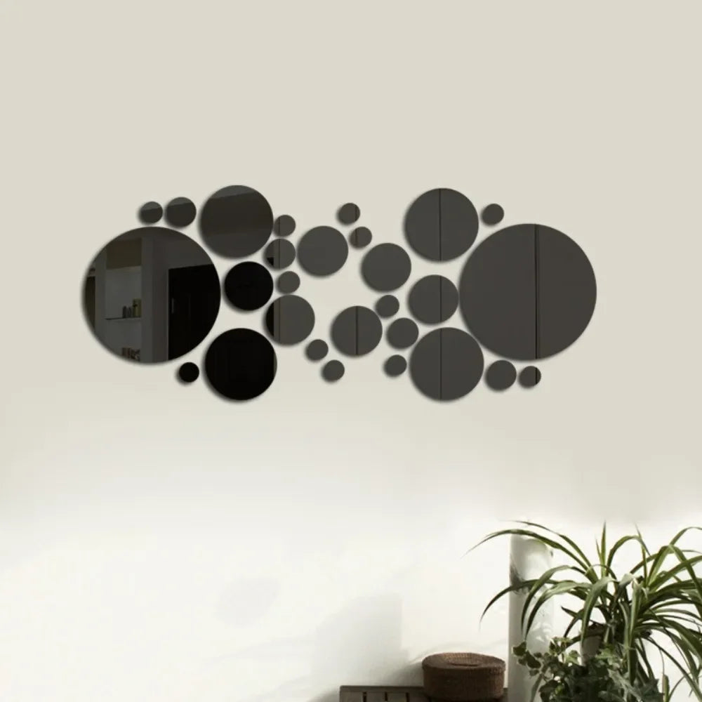 A black circular mirror wall decal design featuring various sized circles arranged in a scattered pattern.