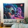 A dark tapestry featuring a vibrant cosmic scene with purple, blue, and orange hues, including an alien figure and a palm tre