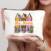 A cream-colored canvas makeup bag featuring three colored pencils with floral accents.