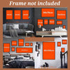 A display of various sized orange framed art pieces on a dark wall and a bed with bedding.