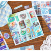 A sheet of retro cartoon PET die cut stickers for scrapbooking and journaling is displayed on a wooden surface.