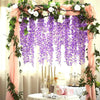 Arche florale décorée de draperies roses et de guirlandes de wisteria artificielle violette.