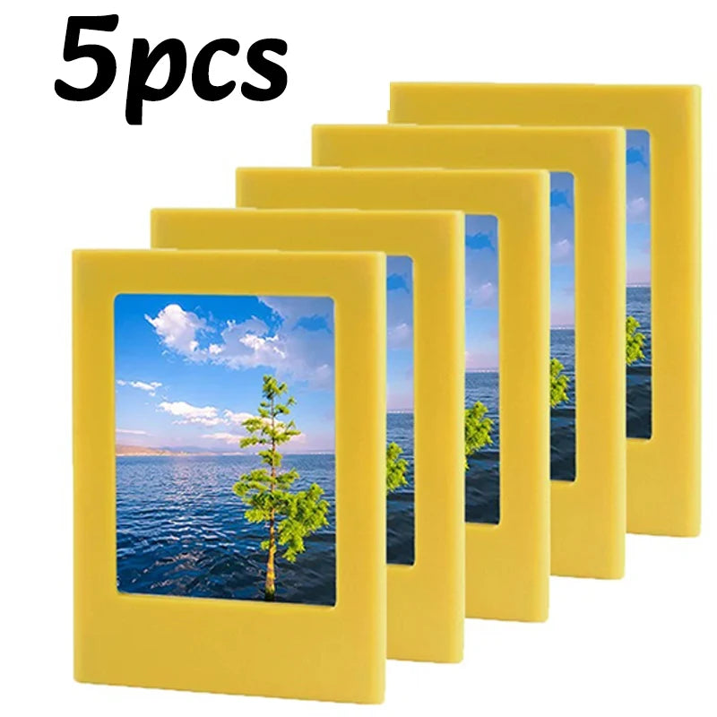Five yellow magnetic photo frames or fridge magnets displayed in a row.