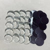 A collection of round decorative refrigerator magnets in silver and black finishes.